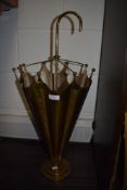 A brass stick stand in the form of an umbrella having embossed design