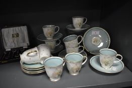 A fine selection of tea cups and saucers by Susie Cooper in the Azalea design