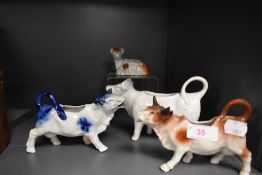 A selection of ceramic cow style creamers or milk jugs