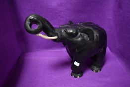 A large African ethnic wood carved figure of a fat elephant