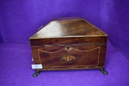 A fine Edwardian casket form tea caddy having mahogany and inlayed case