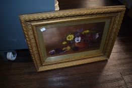 An oil on board of a still life scene in a gilt and gesso picture frame