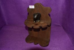 A vintage tobacco smokers pipe rack having colonial style elephant decoration in a Mahogany style