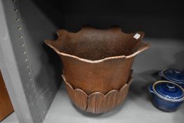 A heavy cast iron planter top in the form of a lotus flower and leaf