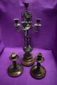 A Victorian bronze table centre candelabra having a gothic design and two wooden candle sticks