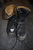 A pair of high top black work or walking boots.
