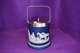 An early 20th century biscuit barrel labelled Tunstall Adams