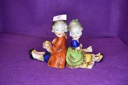 A pair of ceramic book ends possibly German having stamp to base