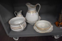 An Ashworth wash jug a bowl vanity set in gilt and white ground
