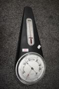 A metal cased barometer having a metal tear drop design case