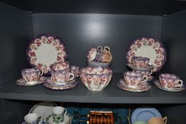 A late Victorian part tea service in pink and purple hues Reg no. 206146