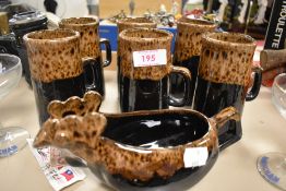 A set of six earthen ware mugs and a matching gravy boat