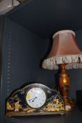 An art deco chinoiserie styled mantle clock well detailed with a similar matching table lamp