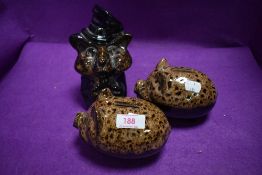 Three ceramic money banks including to piggy banks and a fox with hat