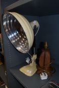 A vintage 1950's heat lamp and similar table lamp with teak base