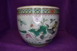 A hard paste Chinese fish or plant bowl hand decorated in a Cantonese design with ducks and pond