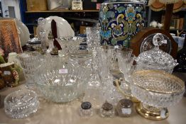 A selection of clear cut and crystal glass wares including atomiser and dressing table items