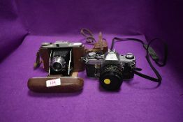 Two photographic film cameras including Canon AE-1 and Pronto