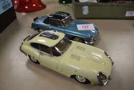 Two mid century cigarette lighters in the form of cars including Jaguar XKE and MGB
