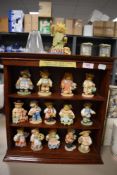 A selection of collectable Cherished Teddies figures and figurines including display stand
