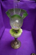 A fine Victorian oil burning lamp by Eltex having brass embossed base with milk glass well and green