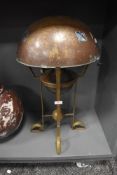 An arts and crafts oil lamp having heavy brass hammered four footed stand with matching hammer