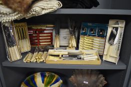 A selection of table wares cutlery and flatware including many cased and boxed sets