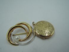 A 9ct white and yellow gold swirl brooch with cultured pearl decoration and a circular 9ct gold