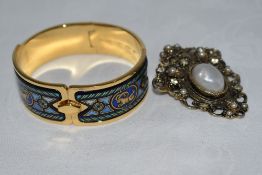 A Michaela Frey hinged gold plated bangle having enamelled Greek style design and concealed clasp,
