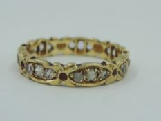 An 18ct gold eternity ring of shaped form having paste stones, size O & approx 3.4g