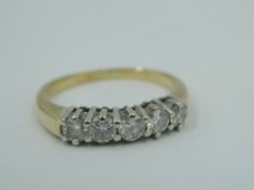 A five stone diamond dress ring, total approx 0.5ct in claw set mounts on an 18ct gold loop, size