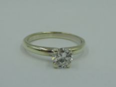 A diamond solitaire dress ring, approx 0.75ct, in a four claw raised mount on a 9ct white gold loop,