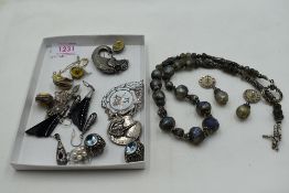 A small selection of silver & white metal jewellery including brooches, earrings and pendants, and