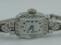 A lady's vintage platinum and diamond cocktail watch by Hamilton having diamond bezel and