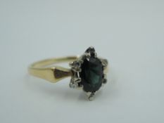 An oval sapphire and diamond chip star cluster to shaped moulded shoulders on a yellow metal loop,
