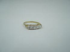 A five stone diamond chip dress ring having an illusionary gallery mount on a 9ct gold loop, size