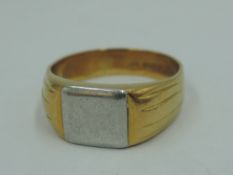 A gent's white and yellow metal; signet ring stamped 18ct having a plain cartouche, size T &
