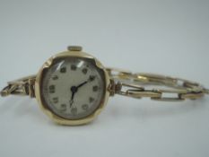 A lady's vintage 9ct gold wrist watch having Arabic numeral dial on a stretch strap stamped 9ct on