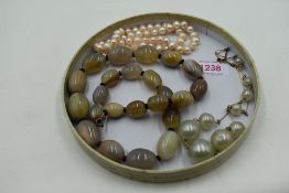 A string of baroque style cultured pearls, over sized simulated pearl and yellow wire necklace and a