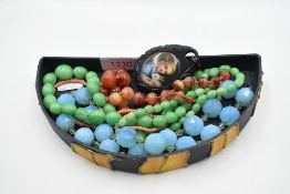 Four strings of beads including painted glass, orange striped agate, coral, and turquoise facetted