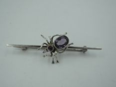 A silver bar brooch by Charles Horner having purple paste set spider to centre, Chester 1921
