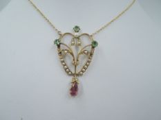 An Edwardian yellow metal pendant stamped 585 having paste and seed pearl decoration on a fixed