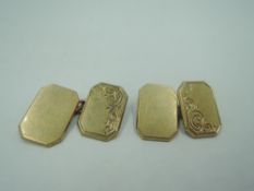 A pair of 9ct gold cufflinks having engraved engraved scroll decoration to panels and chain