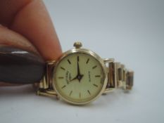 A 9ct gold wrist watch by Rotary having a baton numeral dial to champagne face in gold case with
