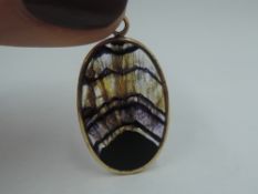 An oval Blue John agate pendant of oval form in a 9ct gold mount