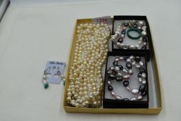 A selection of modern white and coloured baroque style jewellery and a malachite band ring