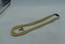 A double row of graduated cultured pearls having a silver box clasp with marcasite decoration,