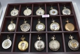 A tray containing a collection of 14 modern collector's corner style pocket watches and a gold