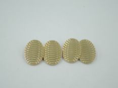 A pair of 9ct gold oval panel cufflinks having engraved decoration and chain connectors, approx 14g