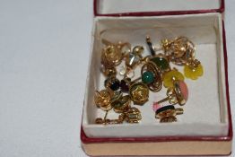 Eleven pairs of yellow metal stud earrings of various forms including, coral, opal, etc, approx 13.